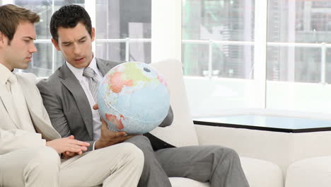 Geschäftsleute-Die-Einen-Globus-Betrachten-