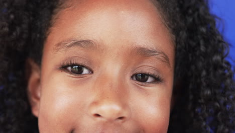 Primer-Plano-De-Una-Chica-Birracial-Con-Cabello-Rizado-Y-Una-Sonrisa-Sutil