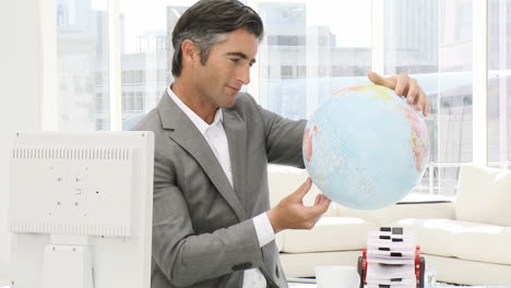 -Elegant-business-man-holding-a-terrestrial-globe