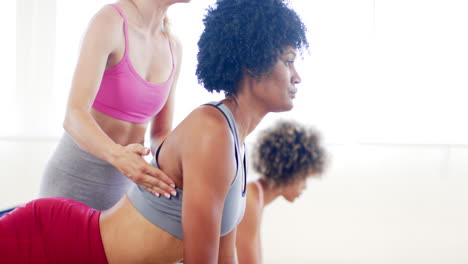 Two-biracial-women-and-one-Caucasian-woman-practicing-yoga