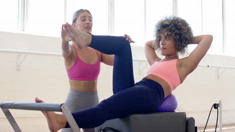 Two-women-are-practicing-yoga-on-equipment