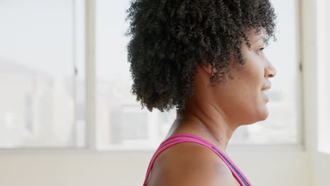 Biracial-woman-with-curly-hair-practicing-yoga