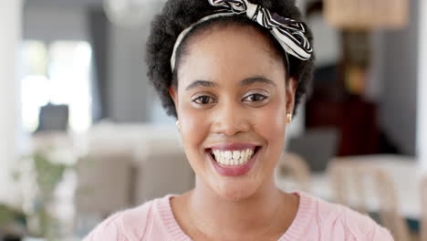 Afroamerikanerin-Lächelt-Herzlich-Zu-Hause,-Ihre-Augen-Funkeln-Vor-Freude