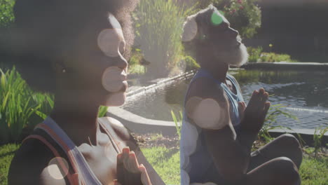 Animation-Von-Lichtpunkten-über-Einem-Afroamerikanischen-Paar-Beim-Yoga,-Meditieren,-Zeitlupe