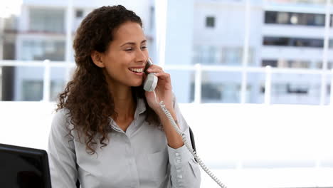 Businesswoman-talking-on-phone-in-office-