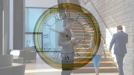 Animation-of-moving-clock-over-asian-businessman-using-smartphone-in-office