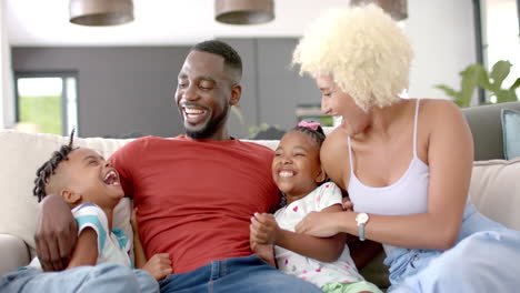 African-American-man,-woman,-and-their-kids-share-joy-at-home