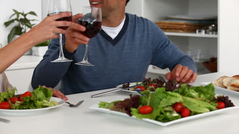 Couple-have-a-happy-dinner-looking-at-the-camera