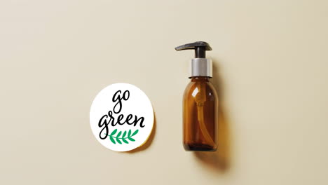 Animation-of-go-green-text-and-leaf-logo-over-lemon-slice-and-beauty-oil-pump-bottle