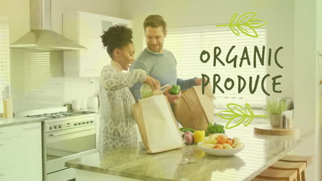 Animation-of-organic-produce-text-over-diverse-couple-preparing-healthy-meal-in-kitchen