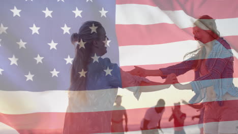 Animation-of-american-flag-over-happy-caucasian-female-friends-dancing-on-sunny-beach