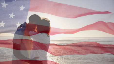 Animation-of-american-flag-over-diverse-couple-embracing-on-sunny-beach