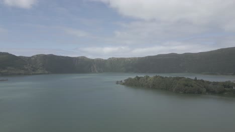 The-stunning-sete-cidades-volcanic-crater-lake-surrounded-by-lush-greenery,-aerial-view