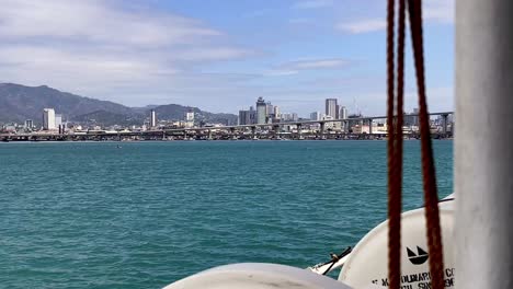 Philippines,-Cebu:-The-video-captures-a-boat-approaching-Cebu-City-and-its-port,-offering-a-scenic-view-of-the-city-from-the-water