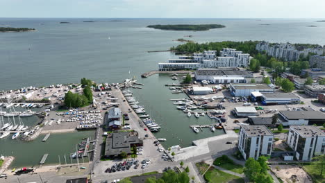 Aerial-tracking-shot-of-the-Lauttasaari-marina,-in-sunny,-summer-day-in-Helsinki
