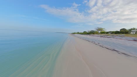 Speed-flight-over-sandy-beach-of-Dominican-Republic-along-clear-Caribbean-Sea