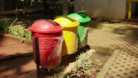 Colorful-recycle-bins-in-a-Southeast-Asian-park-on-a-sunny-day