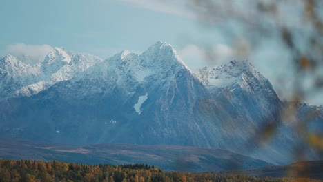 Snow-capped-mountains-fower-above-the-autumn-valley