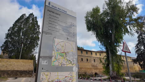 A-directional-sign-in-Nicosia,-Cyprus,-indicating-various-points-of-interest-including-Pafos-Gate,-museums,-and-Eleftheria-Square