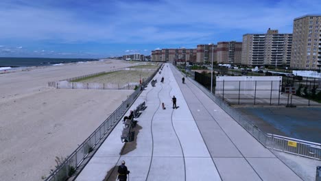 An-aerial-view-of-the-concrete-boardwalk-in-Far-Rockaway,-Queens-on-a-sunny-day