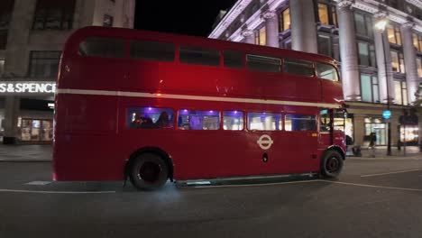 Old-red-double-decker-bus-spews-polution-into-the-night-air