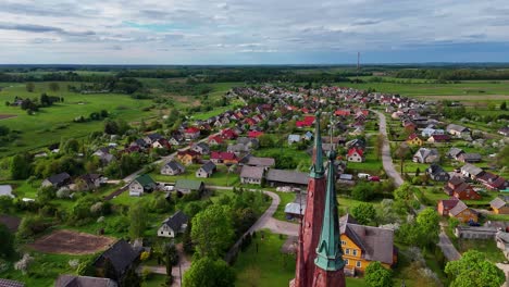 Lithuanian-church-towers-with-scenic-countryside-backdrop,-aerial-view