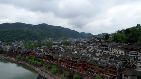 Drone-captures-Snow-Bridge-revealing-traditional-architecture-and-river-view