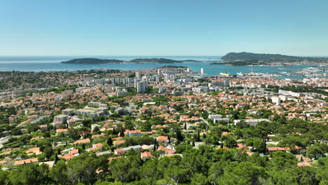 Scenic-aerial-view-of-Toulon,-France,-with-lush-greenery-and-the-Mediterranean-Sea-in-the-background