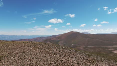 Aerial-establishing-shot-of-the-vast-Andean-mountain-range-and-rural-roads