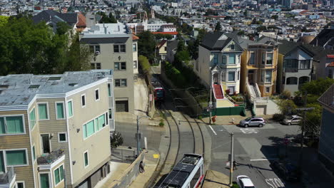 Two-light-rails-passing-each-other-on-the-streets-of-San-Francisco,,-USA---Aerial-view