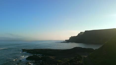 Aerial-shot-of-the-cliffs-at-Giant's-Causeway-in-County-Antrim,-Northern-Ireland-on-an-summer-morning