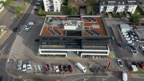 Aerial-of-small-office-building-with-photovoltaic-solar-panels-on-rooftop