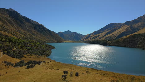 Scenic-Moke-Lake-near-Queenstown,-New-Zealand-glistening-in-sunlight,-aerial-view