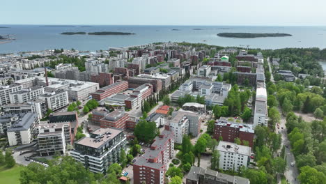 AERIAL-Bird-flying-over-the-Drumso-cityscape,-summer-day-in-Lauttasaari,-Finland