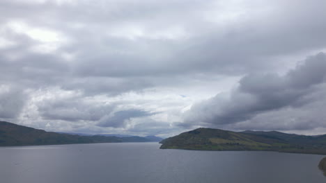 Slow-aerial-flying-over-waters-of-Loch-Ness-on-cloudy-day,-Scotland