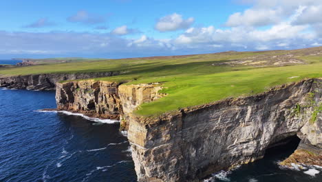Aerial-View-of-Breathtaking-Landscape-of-Scotland-UK,-Steep-Cliffs-Above-Sea-and-Green-Coastal-Pastures