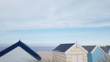 Overlooking-colourful-beach-huts-at-Southwold-seaside-from-sand-dunes