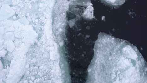 Top-Down-View,-Sailing-in-Arctic-Sea-Water-Covered-With-Broken-Pieces-of-Ice,-Close-Up
