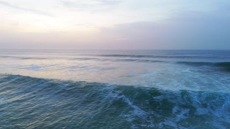 Ocean-huge-turquoise-waves-crashing-at-sunset,-cinematic-golden-light
