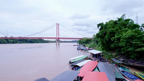 Explore-the-river-coast-with-native-boats-and-the-Continental-Bridge-in-this-aerial-shothot