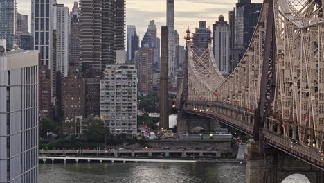 NYC-New-York-Aerial-v344-zoomed-view,-drone-fly-alongside-Queensboro-bridge-over-East-river-towards-Sutton-Place-capturing-cityscape-of-Midtown-Manhattan---Shot-with-Mavic-3-Pro-Cine---September-2023