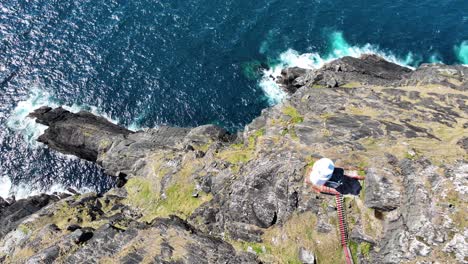 Ireland-Epic-locations-drone-dramatic-view-of-Sheep’s-Head-Lighthouse-with-steep-cliffs-dropping-to-the-sea-hundreds-of-metres-below,West-Cork-dramatic-coast