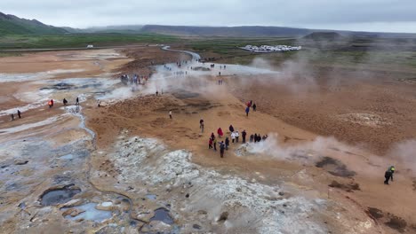 Drone-Shot-of-Tourists-Around-Geysers-and-Hot-Springs-in-Landscape-of-Iceland-60fps