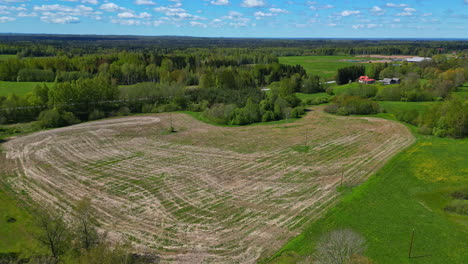 Green-field-with-heavy-traces-of-industrial-machines,-construction-site