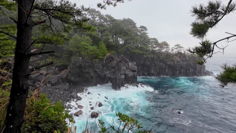 Dramatic-coast-line-in-bad-weather-showing-the-water-crashing-on-the-cliffs-overlooking-from-the-forest-in-Japan