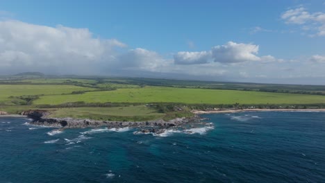 Aerial-panoramic-establishing-coast-near-Hookipa-Maui-sloping-lowlands-on-sunny-day