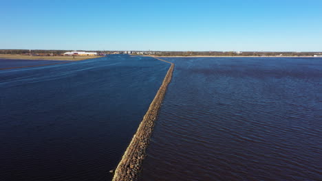 Aerial-Dolly-out-View-of-Pärnu-River's-Protective-Barrier-during-Golden-Hour
