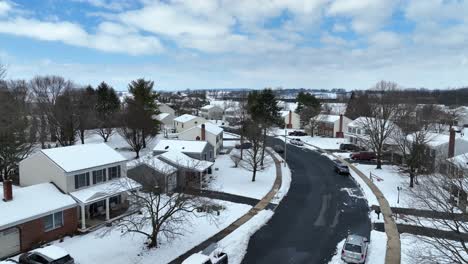 Blue-sky-over-snow-covered-American-neighborhood-during-beautiful-winter-day