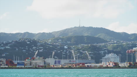 A-ferry-passes-in-front-of-the-sports-stadium-in-Wellington,-New-Zealand