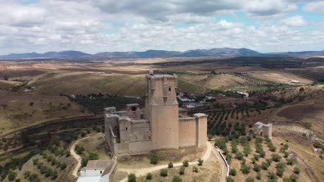 Castillo-De-Belalcázar-En-Córdoba-España-Con-Vasto-Campo-Y-Montañas-Distantes,-Vista-Aérea